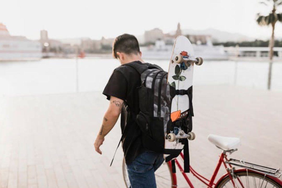 How Do You Put a Skateboard behind a Backpack?